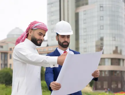 Construction contractors reviewing project plans for residential and commercial development in Saudi Arabia